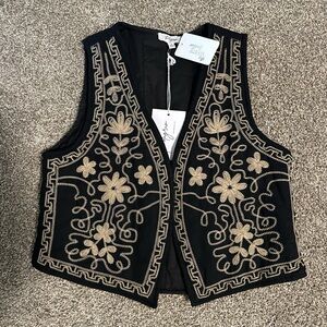 Black and gold stitched vest